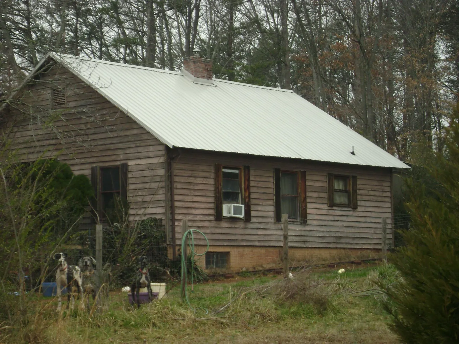 White metal roof on an old wood sided farmhouse, from a Metal Roof Installation job in Milford Square